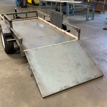 Metal trailer fabrication workshop scene